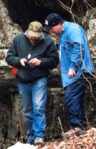 Geocacher 'barramus' inspecting the GPS receiver I found in a nearby rock crevice. Turns out a caver left it there while he went exploring in the Onyx Cave, somewhere under our feet.