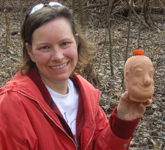 2005 - Elaine shows the "Chia Head" geocache placed by geocacher "dogda" in Cliff Cave Park, St. Louis.