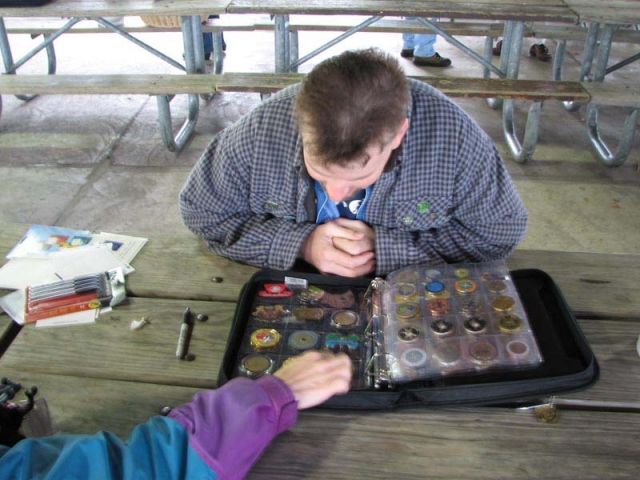 2006 - Geocoin owner showing off their coin collection. SLAGA spring picnic.