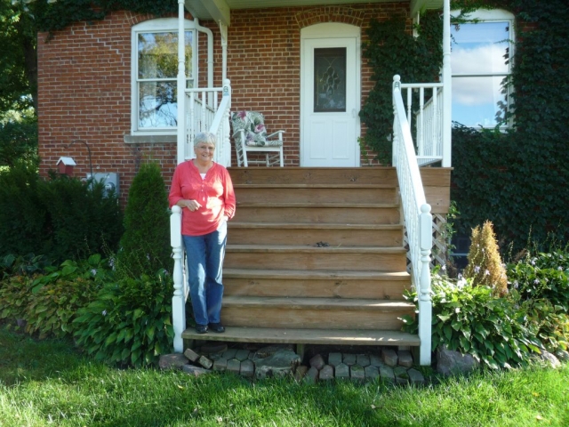Annette (Overgaard) Anderson standing on front porch.  The Koch family (my mother's family) built and lived in this house in the early 1900s.