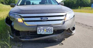 June 12, 2018 - Ludington, MI - Car damage after hitting gas tank in cardboard box