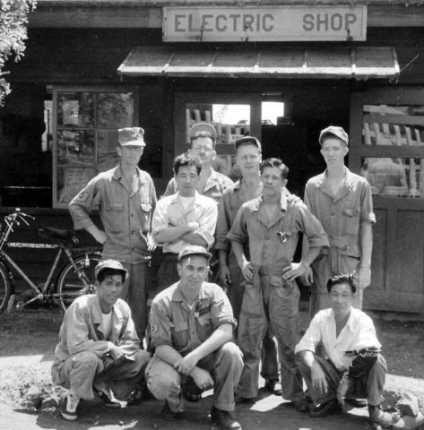 Japan - Walt (front row, middle) at electric shop on base