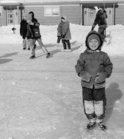 1965. Skating on man-made rink in middle of AFB housing.