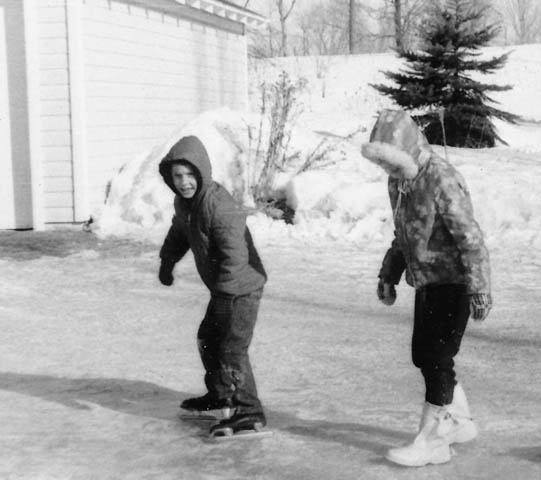 Late 1960s. Me wearing hockey skates on driveway after a frozen rain.