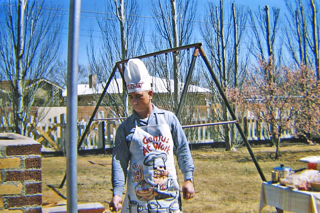 1958 - Clovis, New Mexico.  Walt grilling.