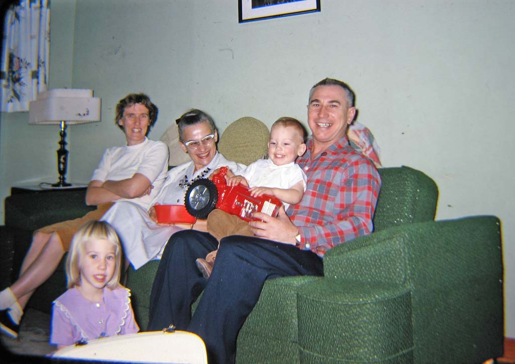 Christmas, 1962.  Clovis, New Mexico.  Helga, Mrs Rinn, Paul with tractor, Walt.  Barb Konopacki on floor.