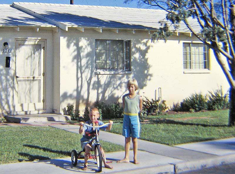 My sister and I in front of the house we lived in at Davis-Monthan AFB in Tucson, Arizona. Our bedroom was the window furthest to the right.