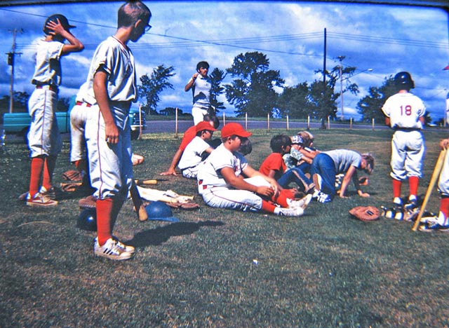 August, 1972. That's me closest to the camera, looking at coach Goulet. This is during a game at the Luck High School ball field.