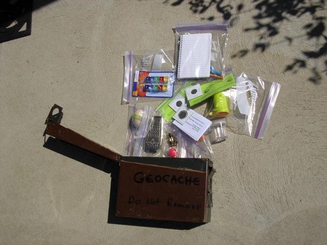 Example of geocache container and content. This is one I was about to hide in the woods. (High value trinket collection, if you ask me!)