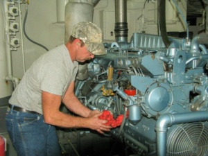 Engineer changing oil on one of the two diesel engines
