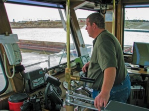 Ex-deckhand - Pilot in training. Notice he steers with levers.