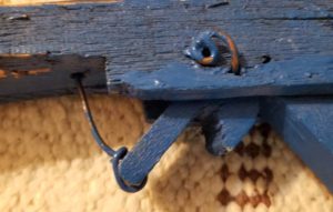 Rubberband gun. Wooden trigger attached to copper wire.