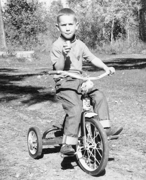 1966 - Me on tricycle in driveway in Luck, Wisconsin